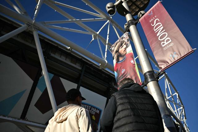 Fans arrive at the Billy Bonds stand ahead of the English Premier League football match between West Ham United and Liverpool at the London Stadium, in London on November 30, 2025. Former West Ham captain and manager Billy Bonds has died at the age of 79, the club has announced today. (Photo by Ben STANSALL / AFP)