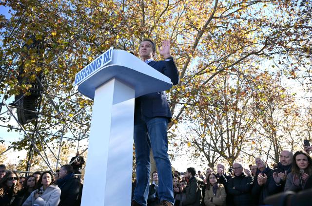 Spain's opposition right-wing Popular Party (PP) leader Alberto Nunez Feijoo speaks on a podium bearing the writing 'Elections now' during a demonstration against corruption called by the PP in front of Debod Temple in Madrid on November 30, 2025. (Photo by Javier SORIANO / AFP)
