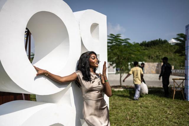 An attendee poses in front of a Polo logo during the Isimi Festival 2025 at the Isimi Wellness and Polo Country Estate in Epe, Lagos State, on November 29, 2025. (Photo by OLYMPIA DE MAISMONT / AFP)