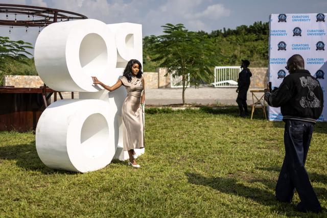 An attendee poses in front of a Polo logo during the Isimi Festival 2025 at the Isimi Wellness and Polo Country Estate in Epe, Lagos State, on November 29, 2025. (Photo by OLYMPIA DE MAISMONT / AFP)