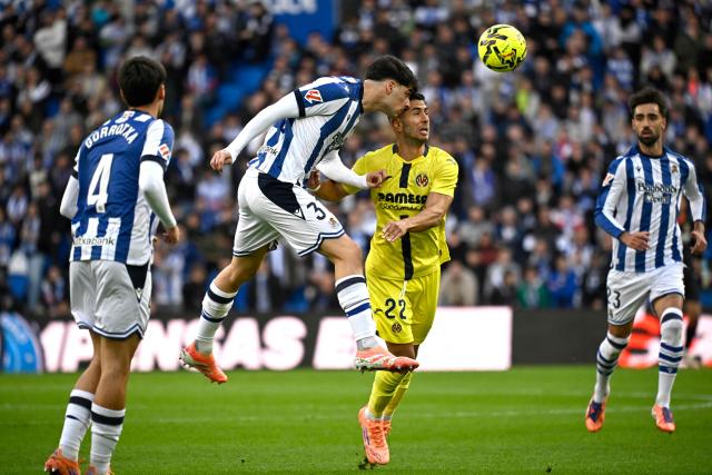 Real Sociedad's Spanish defender #31 Jon Martin fights for the ball with Villarreal's Spanish forward #22 Ayoze Perez Gutierrez during the Spanish league football match between Real Sociedad and Villarreal CF at Anoeta Stadium in San Sebastian on November 30, 2025. (Photo by ANDER GILLENEA / AFP)