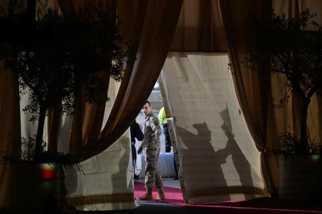 A member of the security forces gestures prior to a welcome ceremony for Pope Leo XIV's arrival at Beirut International Airport, in the Lebanese capital, on November 30, 2025. Pope Leo XIV is heading to Lebanon with a message of peace for the crisis-hit nation after wrapping up a four-day trip to Turkey's tiny Christian community that focused on unity within the Church. (Photo by Jewel SAMAD / AFP)