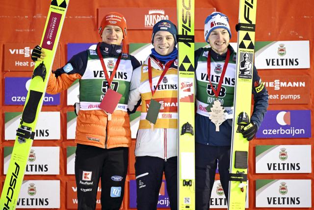 Second placed Julian Schmid of Germany (L), winner Johannes Lamparter of Austria (C) and third placed Ilkka Herola of Finland celebrate on the podium during the medal ceremony of the Nordic Combined competition at the FIS World Cup Ruka Nordic in Kuusamo, Finland on November 30, 2025. (Photo by Roni Rekomaa / Lehtikuva / AFP) / Finland OUT