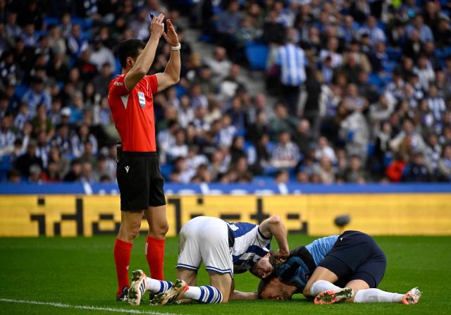 Real Sociedad's Spanish defender #06 Aritz Elustondo tends to Real Sociedad's Spanish goalkeeper #01 Alex Remiro on the ground during the Spanish league football match between Real Sociedad and Villarreal CF at Anoeta Stadium in San Sebastian on November 30, 2025. (Photo by ANDER GILLENEA / AFP)