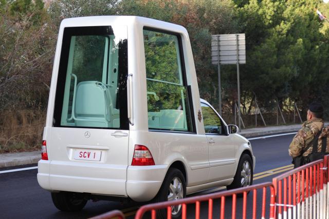 A Lebanese army soldier watches the empty Popemobile, which will be used to transport Pope Leo XIV, drive along a newly asphalted road in Beirut's eastern suburb of Hazmieh, on November 30, 2025. Pope Leo XIV wrapped up a four-day trip to Turkey on November 30, 2025, after a warm welcome by its tiny Christian community, before heading to Lebanon with a message of peace for the crisis-mired nation. (Photo by AFP)