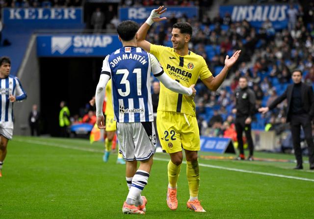 Real Sociedad's Spanish defender #31 Jon Martin and Villarreal's Spanish forward #22 Ayoze Perez Gutierrez gesture during the Spanish league football match between Real Sociedad and Villarreal CF at Anoeta Stadium in San Sebastian on November 30, 2025. (Photo by ANDER GILLENEA / AFP)
