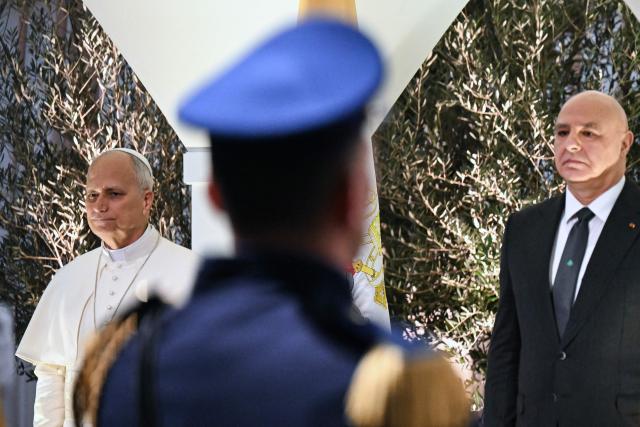 Pope Leo XIV (L) stands next to Lebanon's President Joseph Aoun during a welcome ceremony upon arriving at Beirut International Airport, in the Lebanese capital, on November 30, 2025. Pope Leo XIV arrived in Lebanon for a two-day trip where he is expected to bring a message of peace, an AFP journalist aboard the plane said. (Photo by Jewel SAMAD / AFP)
