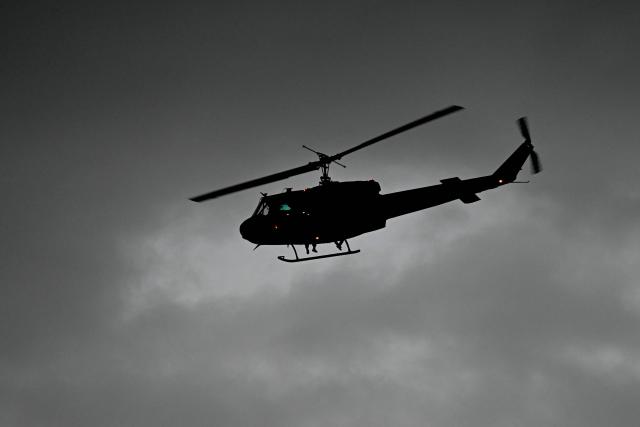 A Lebanese military helicopter hovers over the motorcade of Pope Leo XIV after a welcoming ceremony at Beirut International Airport, in the Lebanese capital, on November 30, 2025. Pope Leo XIV arrived in Lebanon for a two-day trip where he is expected to bring a message of peace, an AFP journalist aboard the plane said. (Photo by Jewel SAMAD / AFP)