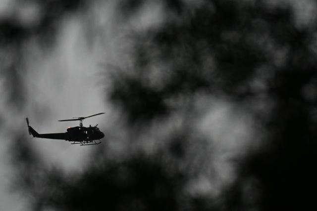 A Lebanese military helicopter hovers over the motorcade of Pope Leo XIV after a welcoming ceremony at Beirut International Airport, in the Lebanese capital, on November 30, 2025. The American pontiff landed in Beirut from Turkey and is set to meet Lebanon's president, the Arab world's only Christian head of state, and deliver a speech to authorities and diplomats at the presidential palace later in the afternoon. (Photo by Jewel SAMAD / AFP)