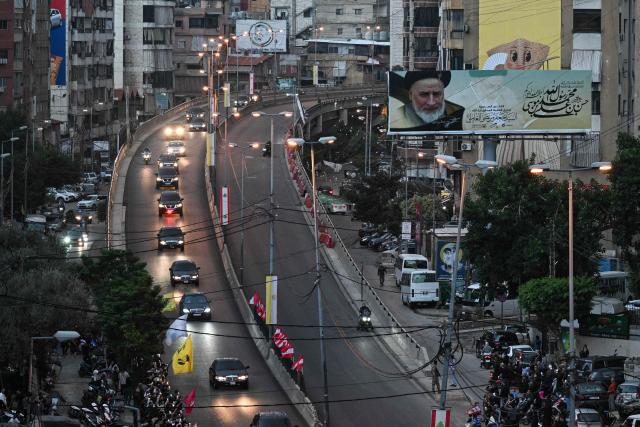 The convoy of Pope Leo XIV drives through Beirut's southern suburbs, a packed residential area known as Dahiyeh, which is also a Hezbollah bastion, on November 30, 2025. Pope Leo XIV arrived in Lebanon on November 30 with a message of peace for the crisis-hit nation, still reeling from a war between Israel and Hezbollah and the conflict's lingering aftereffects. (Photo by JOSEPH EID / AFP)