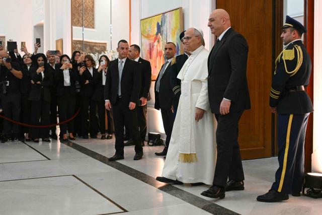 Pope Leo XIV arrives with Lebanon's President Joseph Aoun for a meeting with authorities, civil society and diplomatic corps at the presidential palace in Baabda, east of the capital Beirut, on November 30, 2025.  (Photo by Andreas SOLARO / AFP)