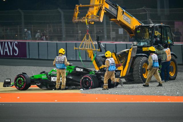 Marshals remove Kick Sauber's German driver Nico Hulkenberg's stricken car from the track during the Formula One Qatar Grand Prix at the Lusail International Circuit in Lusail on November 30, 2025. (Photo by Andrej ISAKOVIC / AFP)
