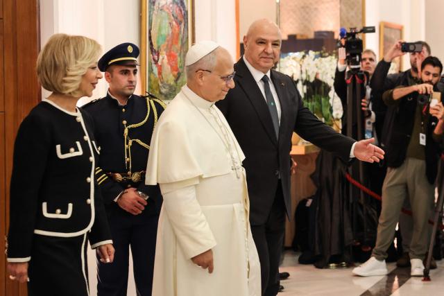 Pope Leo XIV walks alongside Lebanon's President Joseph Aoun (back) and first lady Nehmat Nehme (L) during a meeting at the presidential palace in Baabda, east of the capital Beirut, on November 30, 2025. Pope Leo XIV arrived in Lebanon on November 30 with a message of peace for the crisis-hit nation, still reeling from a war between Israel and Hezbollah and the conflict's lingering aftereffects. (Photo by anwar amro / AFP)