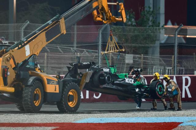 Marshals remove Kick Sauber's German driver Nico Hulkenberg's stricken car from the track during the Formula One Qatar Grand Prix at the Lusail International Circuit in Lusail on November 30, 2025. (Photo by Karim JAAFAR / AFP)