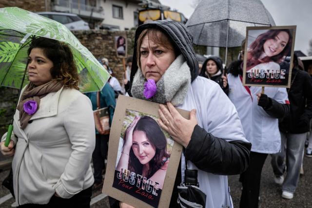 A woman holds a placard picturing Zaia Binet, a 27-year-old nursing assistant found dead in her car on November 19, 2025, in Saint-Marcel-Bel-Accueil, during a march in her honour and in tribute to all women who are victims of violence, in Cremieu, central eastern France, on November 30, 2025, (Photo by ARNAUD FINISTRE / AFP)