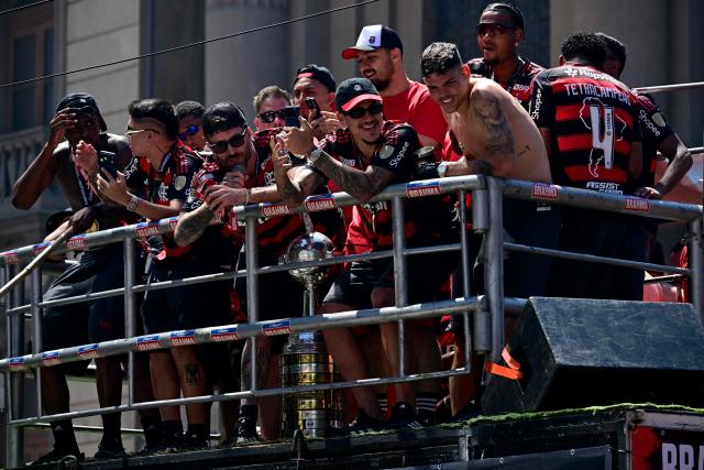 Flamengo's defender Leo Pereira (3-L) speaks during a celebration with fans in Rio de Janeiro, Brazil, on November 30, 2025, a day after clinching the 2025 Copa Libertadores title. (Photo by Pablo PORCIUNCULA / AFP)