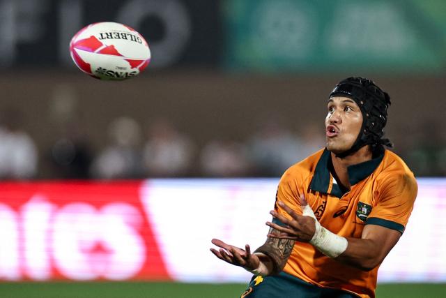Australia's #4 Dietrich Roache catches the ball during the men's HSBC World Rugby Sevens Series final match between Australia and New Zealand at the Sevens Stadium in Dubai on November 30, 2025. (Photo by FADEL SENNA / AFP)