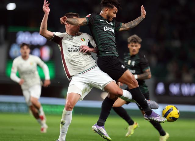 Estrela da Amadora's Brazilian defender #14 Bernardo Schappo (L) and Sporting Lisbon's Colombian forward #97 Luis Suarez fight for the ball during the Portuguese League football match between Sporting CP and CF Estrela da Amadora at Jose Alvalade stadium in Lisbon on November 30, 2025. (Photo by PATRICIA DE MELO MOREIRA / AFP)