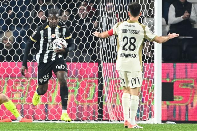 Angers' Cameroonian forward #31 Harouna Djibirin (L) celebrates after scoring his team's first goal during the French L1 football match between SCO Angers and RC Lens at the Stade Raymond-Kopa in Angers on November 30, 2025. (Photo by JEAN-FRANCOIS MONIER / AFP)