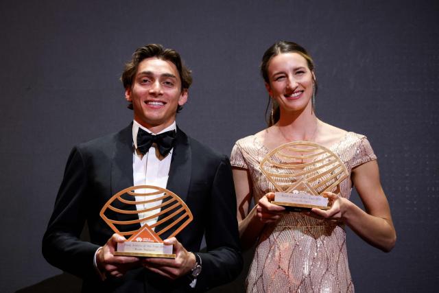 Sweden's world pole vault champion Armand Duplantis (L) holds his Men’s field athlete of the year award and Australia's world high jump champion Nicola Olyslagers (R) holds her Women’s field athlete of the year award as they pose on stage during the World Athletics Awards 2025 in Monaco, on November 30, 2025. (Photo by Valery HACHE / AFP)
