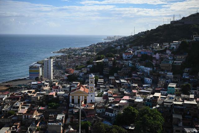 Aerial view of Los Olivos neighborhood in La Guaira, Venezuela, on November 30, 2025. US President Donald Trump sharply escalated his threats against Venezuela on Saturday with an ominous warning that the country's airspace should be considered "closed," raising fears of imminent military action. (Photo by Federico PARRA / AFP)