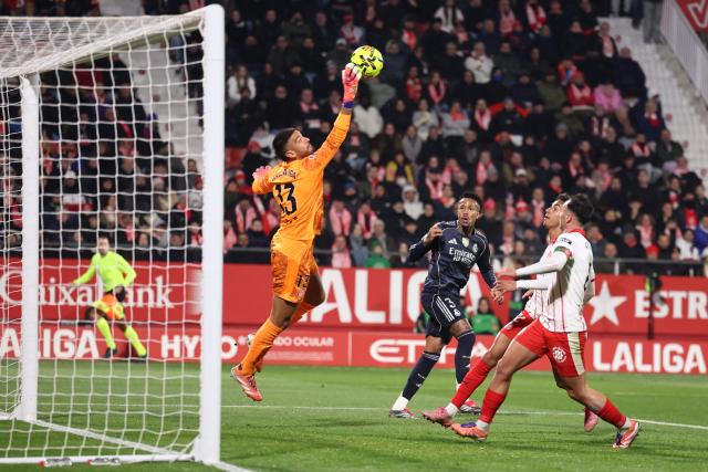 Girona's Argentine goalkeeper #13 Paulo Gazzaniga jumps to make a save during the Spanish league football match between Girona FC and Real Madrid CF at Montilivi Stadium in Girona on November 30, 2025. (Photo by Josep LAGO / AFP)