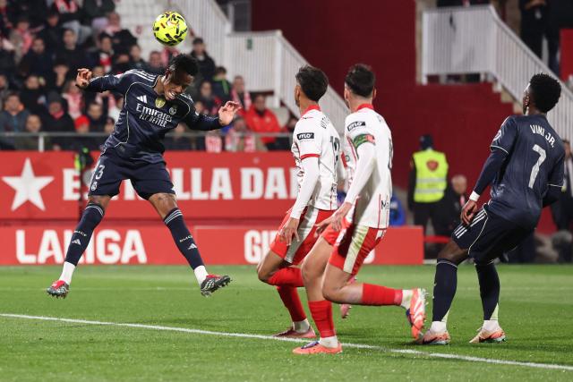 Real Madrid's Brazilian defender #03 Eder Militao heads the ball during the Spanish league football match between Girona FC and Real Madrid CF at Montilivi Stadium in Girona on November 30, 2025. (Photo by Josep LAGO / AFP)