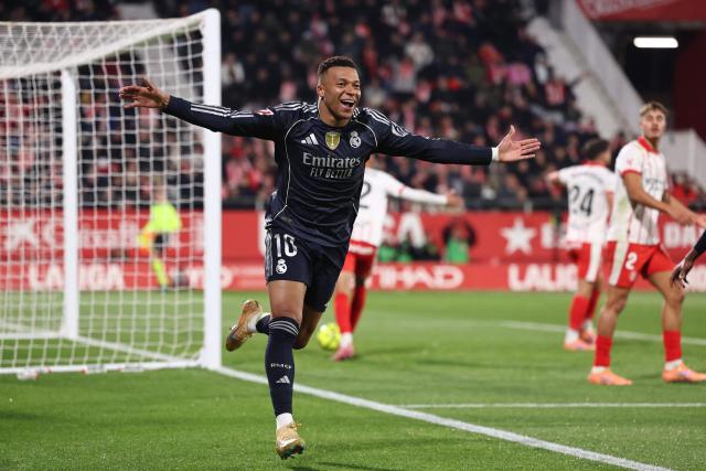 Real Madrid's French forward #10 Kylian Mbappe celebrates scoring the opening goal during the Spanish league football match between Girona FC and Real Madrid CF at Montilivi Stadium in Girona on November 30, 2025. (Photo by Josep LAGO / AFP)