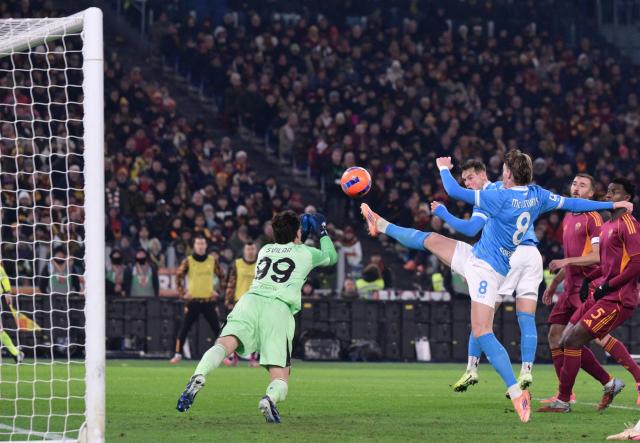 Roma's Serbian goalkeeper #99 Mile Svilar dives to make a save on Napoli's Scottish midfielder #08 Scott McTominay during the Italian Serie A football match between AS Roma and Napoli at the Olympic Stadium in Rome on November 30, 2025. (Photo by Tiziana FABI / AFP)