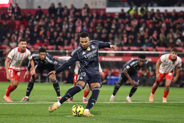 TOPSHOT - Real Madrid's French forward #10 Kylian Mbappe scores a goal from the penalty spot during the Spanish league football match between Girona FC and Real Madrid CF at Montilivi Stadium in Girona on November 30, 2025. (Photo by Josep LAGO / AFP)