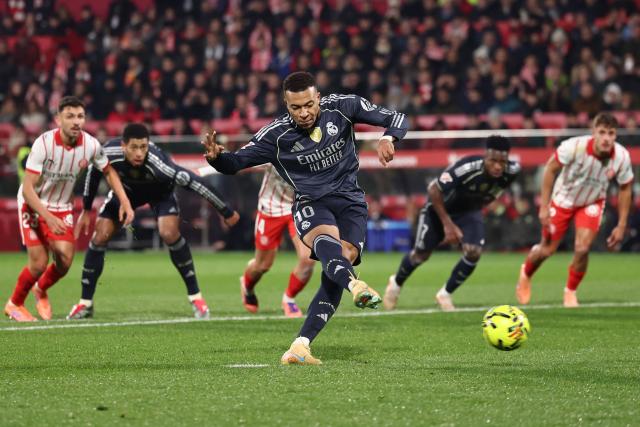 Real Madrid's French forward #10 Kylian Mbappe scores a goal from the penalty spot during the Spanish league football match between Girona FC and Real Madrid CF at Montilivi Stadium in Girona on November 30, 2025. (Photo by Josep LAGO / AFP)