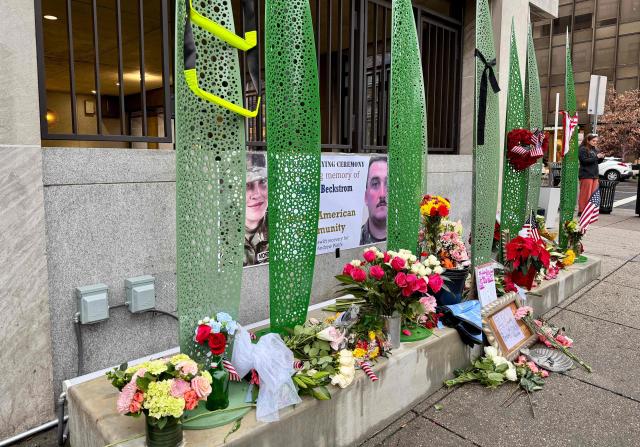 Flowers and notes are placed at a makeshift memorial for the two National Guard members who were shot near the White House, in Washington, DC, November 30, 2025. Two National Guard troops, Staff Sgt. Andrew Wolfe and Specialist Sarah Beckstrom, were shot on November 26 near the White House in what authorities described as a targeted attack by an Afghan migrant who had previously worked with the US military in Afghanistan, a case now being treated as a terrorism investigation. (Photo by Daniel SLIM / AFP)
