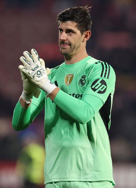 Real Madrid's Belgian goalkeeper #01 Thibaut Courtois claps at the end of the Spanish league football match between Girona FC and Real Madrid CF at Montilivi Stadium in Girona on November 30, 2025. (Photo by Josep LAGO / AFP)