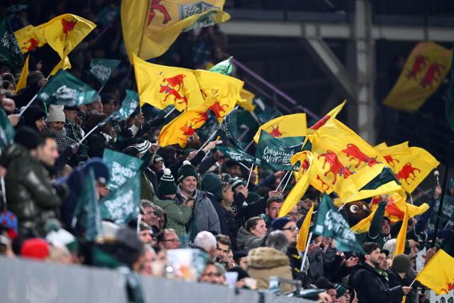 Pau's supporters celebrate after their team's try during the French Top 14 rugby union match between Section Paloise Bearn Pyrenees (Pau) and Stade Rochelais (La Rochelle) at Stade du Hameau in Pau, south-western France on November 30, 2025. (Photo by Gaizka IROZ / AFP)