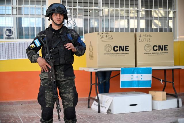 A Honduran army soldier stands guard during Honduras' general election at a polling station in Tegucigalpa on November 30, 2025. Hondurans voted for president on November 30, 2025, amid threats by US President Donald Trump to cut aid to the country if his preferred candidate loses. (Photo by Orlando SIERRA / AFP)