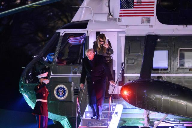 US President Donald Trump and First Lady Melania Trump step off Marine One after landing on the South Lawn upon arrival at the White House in Washington, DC, on November 30, 2025. Trump returned to Washington after spending the Thanksgiving holiday at his Palm Beach, Florida resort. (Photo by Mandel NGAN / AFP)