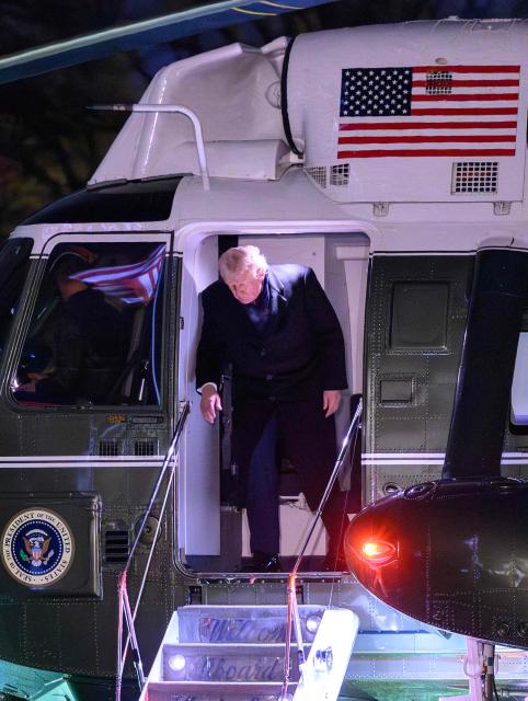 US President Donald Trump steps off Marine One after landing on the South Lawn upon arrival at the White House in Washington, DC, on November 30, 2025. Trump returned to Washington after spending the Thanksgiving holiday at his Palm Beach, Florida resort. (Photo by Mandel NGAN / AFP)