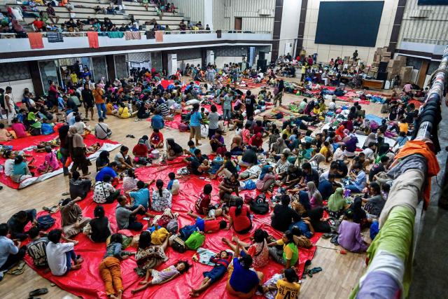 Displaced residents rest in a shelter following flash floods and landslides in Pandan in Central Tapanuli, Indonesia's North Sumatra province on November 30, 2025. The death toll from floods that hit Indonesia this week has risen to more than 300 people, according to figures from the disaster agency on November 29. (Photo by YT Hariono / AFP)