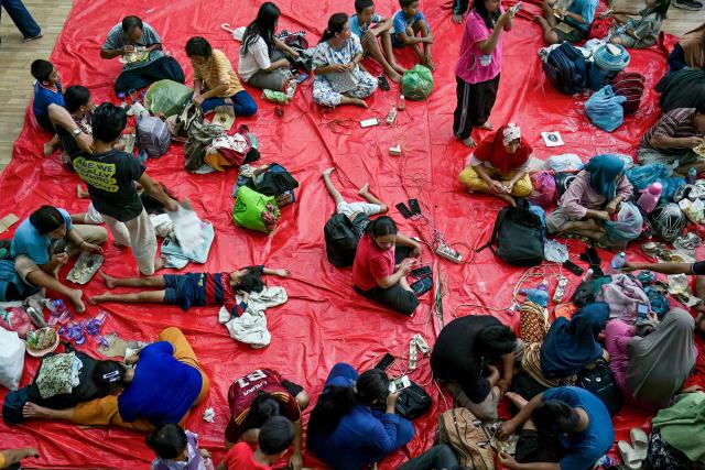 Displaced residents rest in a shelter following flash floods and landslides in Pandan in Central Tapanuli, Indonesia's North Sumatra province on November 30, 2025. The death toll from floods that hit Indonesia this week has risen to more than 300 people, according to figures from the disaster agency on November 29. (Photo by YT Hariono / AFP)