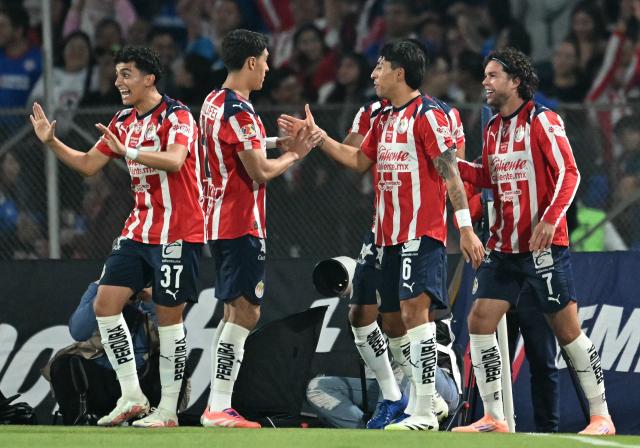 Guadalajara's US forward #07 Cade Cowell celebrates with teammates after scoring the opening goal during the Liga MX Apertura quarter-final second leg football match between Cruz Azul and Guadalajara at the Olimpico Universitario Stadium in Mexico City on November 30, 2025. (Photo by YURI CORTEZ / AFP)