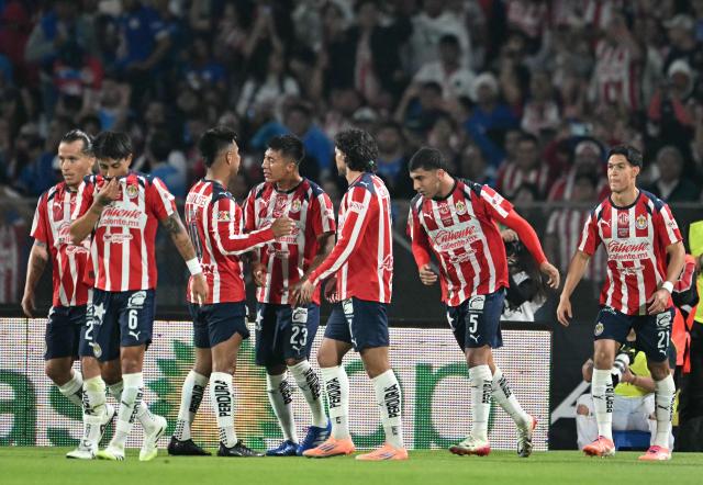 Guadalajara players celebrate after scoring their second goal during the Liga MX Apertura quarter-final second leg football match between Cruz Azul and Guadalajara at the Olimpico Universitario Stadium in Mexico City on November 30, 2025. (Photo by YURI CORTEZ / AFP)