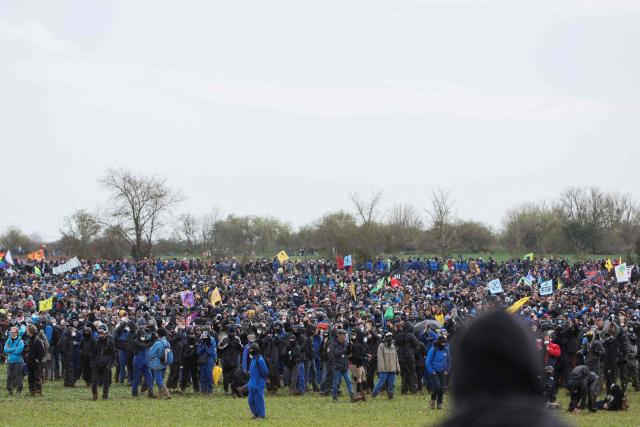 (FILES) Protestors gather during a demonstration called by the collective "Bassines non merci", the environmental movement "Les Soulevements de la Terre" and the French trade union 'Confederation paysanne' to protest against the construction of a new water reserve for agricultural irrigation, in Sainte-Soline, central-western France, on March 25, 2023. The appeal trial of four union and collective leaders convicted for "organizing an illegal demonstration" in Sainte-Soline will take place in Poitiers, western France, on December 3, 2025. (Photo by Yohan BONNET / AFP)