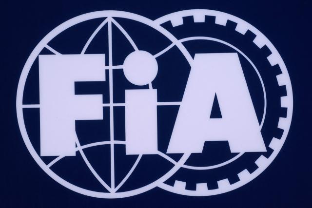 (FILES) A logo of the Federation Internationale de l'Automobile (FiA) is pictured at the Bahrain International Circuit in Sakhir on March 1, 2024, ahead of the Bahrain Formula One Grand Prix. The court will give its decision on the election system for the FIA presidency, in Paris on December 3, 2025. (Photo by Giuseppe CACACE / AFP)
