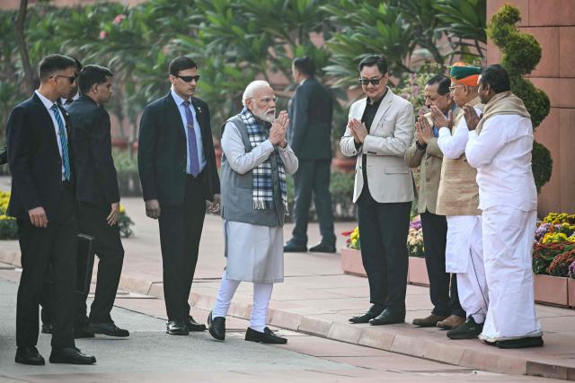 India's Prime Minister Narendra Modi (4L) greets fellow lawmakers upon his arrival for a media address on the first day of the Parliament's winter session in New Delhi on December 1, 2025. (Photo by Sajjad HUSSAIN / AFP)