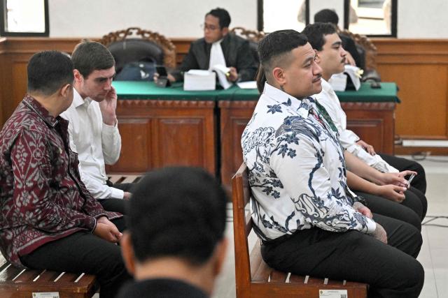 Australian suspect Paea-I-Middlemore Tupou (2nd R), Australian suspect Mevlut Coskun (R), and Australian suspect Darcy Francesco Jenson (2nd L) attend a hearing as part of a trial at a courtroom in Denpasar on Indonesia's resort island of Bali on December 1, 2025. The trial of three Australians accused of plotting the murder of a compatriot at a villa in Bali continues, with all facing the death penalty. (Photo by SONNY TUMBELAKA / AFP)