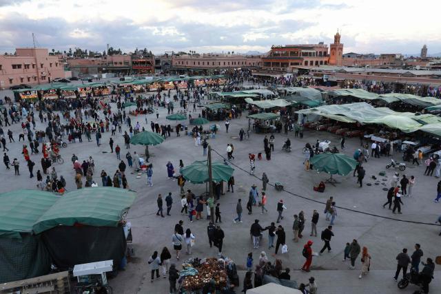 Locals and tourists gather for food and entertainment in Jemaa el-Fna Square or Jamaa Lafna, listed as UNESCO Cultural Heritage site, located in the heart of the Medina of the city of Marrakech on November 30, 2025. (Photo by Abdel Majid BZIOUAT / AFP)