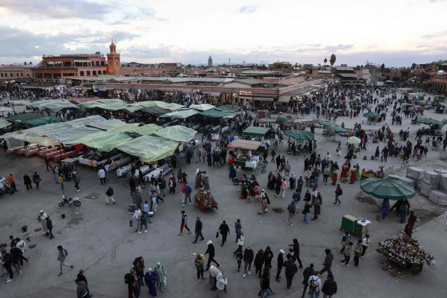 Locals and tourists gather for food and entertainment in Jemaa el-Fna Square or Jamaa Lafna, listed as UNESCO Cultural Heritage site, located in the heart of the Medina of the city of Marrakech on November 30, 2025. (Photo by Abdel Majid BZIOUAT / AFP)