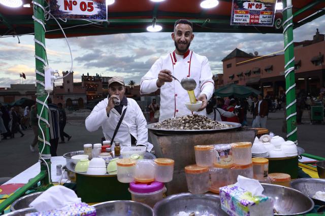 Snail vendors serve customers in Jemaa el-Fna Square or Jamaa Lafna, listed as UNESCO Cultural Heritage site, located in the heart of the Medina of the city of Marrakech on November 30, 2025. (Photo by Abdel Majid BZIOUAT / AFP)