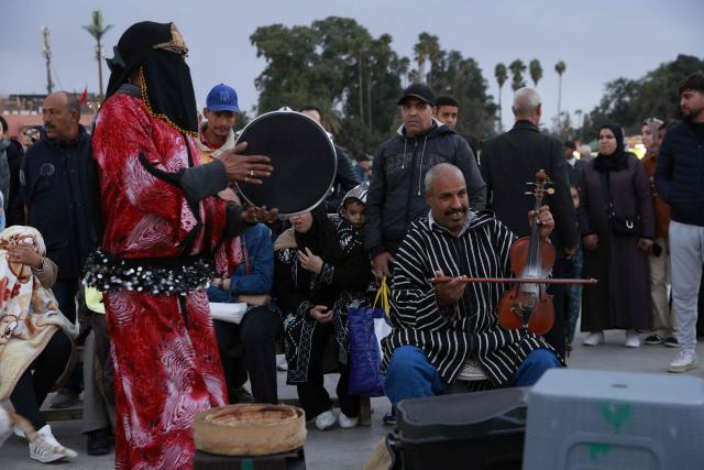 Musicians entertain the crowds in Jemaa el-Fna Square or Jamaa Lafna, listed as UNESCO Cultural Heritage site, located in the heart of the Medina of the city of Marrakech on November 30, 2025. (Photo by Abdel Majid BZIOUAT / AFP)