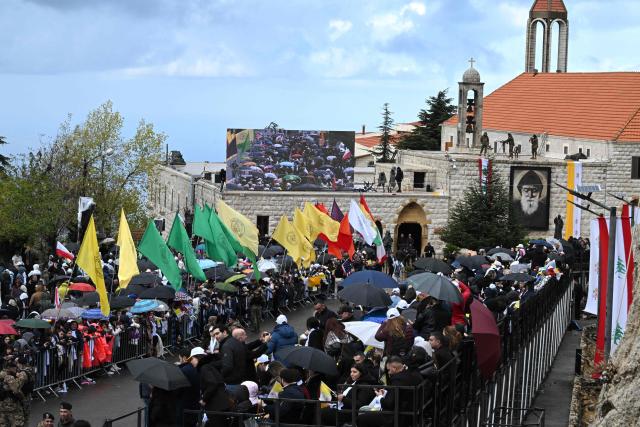 Crowds gather for the arrival of Pope Leo XIV to the tomb of Saint Charbel Makhlouf or Mar Charbel in Arabic, a Lebanese Maronite monk and priest, at the Saint Maron monastery in the mountainous village of Annaya, north of the capital Beirut on December 1, 2025. Pope Leo XIV is set to urge peace and unity on his second day in Lebanon on December 1, 2025, bringing a message of hope to young people whose faith in their crisis-hit country has dwindled. (Photo by JOSEPH EID / AFP)